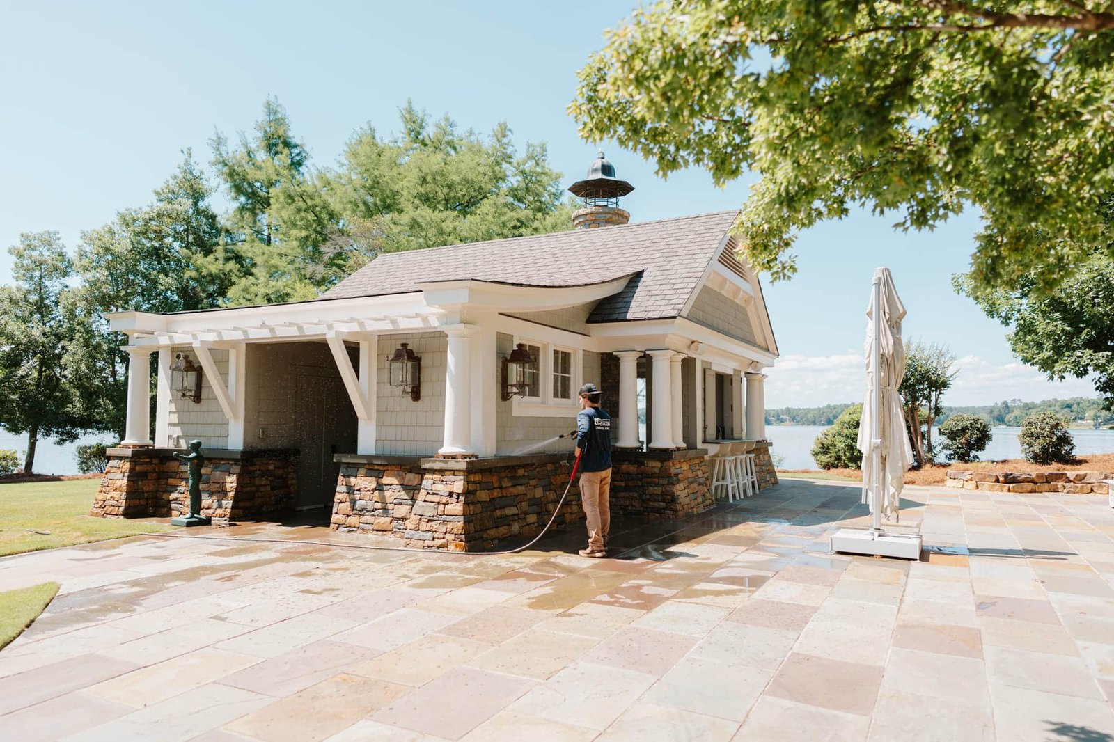 Pure Pressure Pro Wash technician cleaning a Lake Oconee lake house and patio